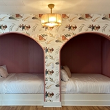 Alpaca themed wallpaper and two beds.