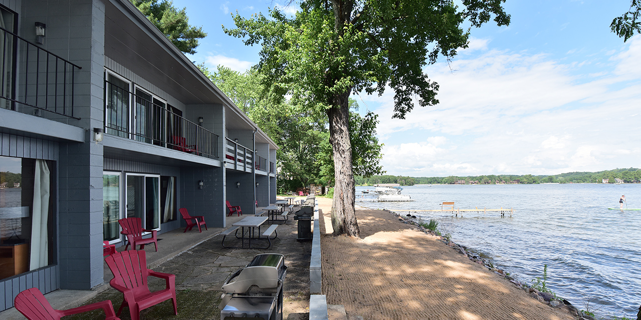 Delton Oaks Resort exterior with lake shore.