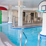 Indoor pool with basketball hoops and splash area.