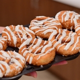 Glazed donuts on a tray.