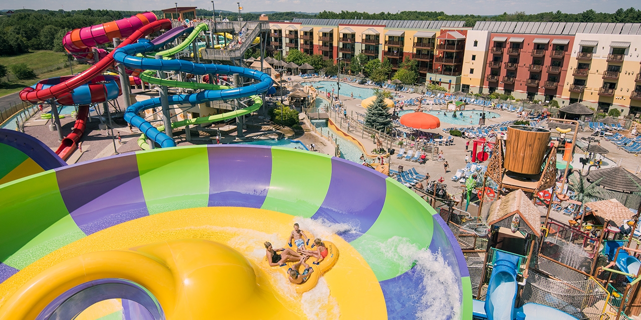 Outdoor waterpark with slides and pools.