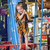 A child plays in an indoor amusement park.