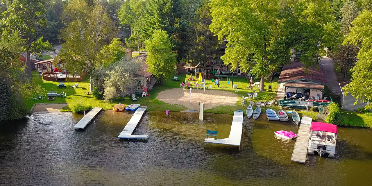 Beach area with piers and boats.