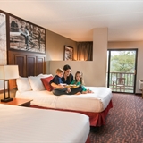 A family spending time in a bedroom at Chula Vista Resort.
