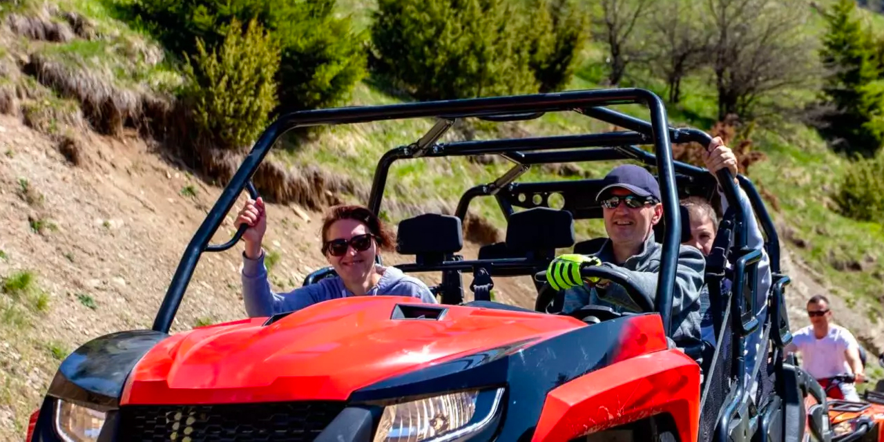 People riding ATVs in the summer.