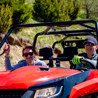 People riding ATVs in the summer.