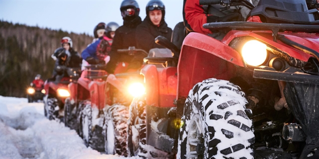 ATVs in snow from Adrenaline Rush Sports in Wisconsin Dells.