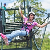 A woman zips from a tower at BigFoot Zipline Tours in Wisconsin Dells.