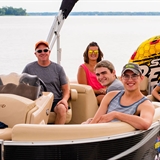 A family relaxing on a pontoon boat.