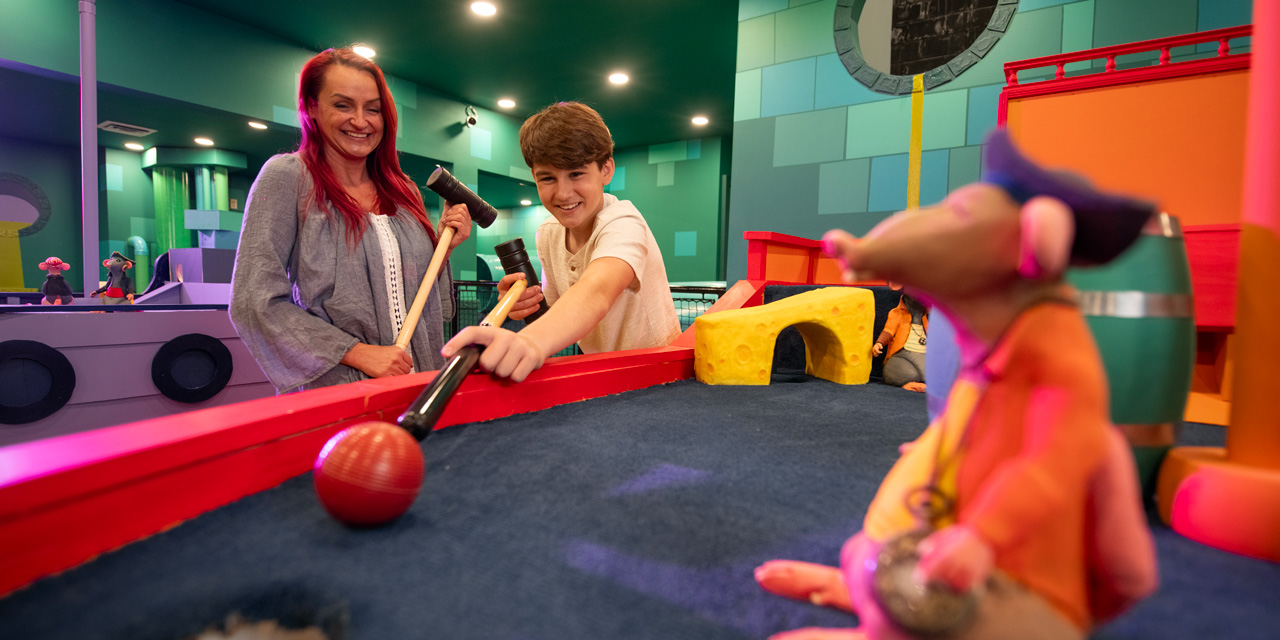 Mother and son playing a game of croquet in a fun environment.