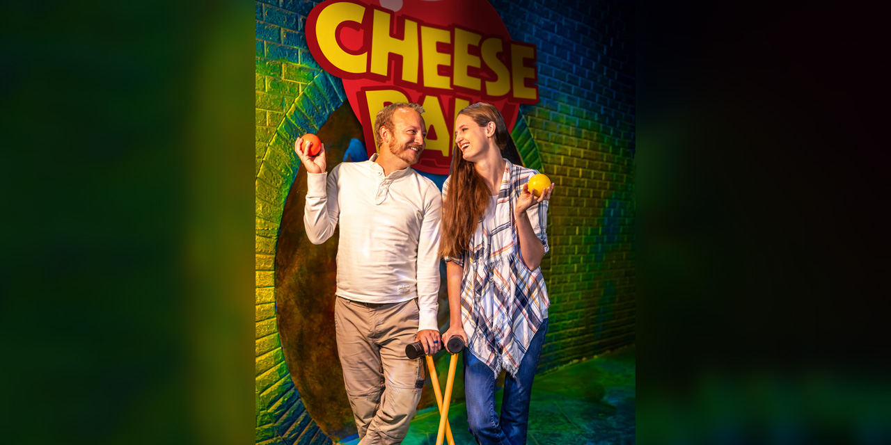 A couple holding croquet ball and mallet.