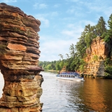 Visitors pass by the Wisconsin Dells scenery on a Dells Boat Tours boat.