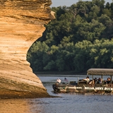 Guests admire the unique rock formations as the sun sets.