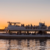 Guests enjoy their time on the Dells Boat Tour Sunset Dinner Cruise as the sun sets on the horizon.