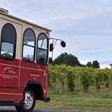 A trolley stops at a local winery.