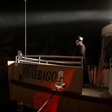 A mysterious man stands at the front of the ghost boat.