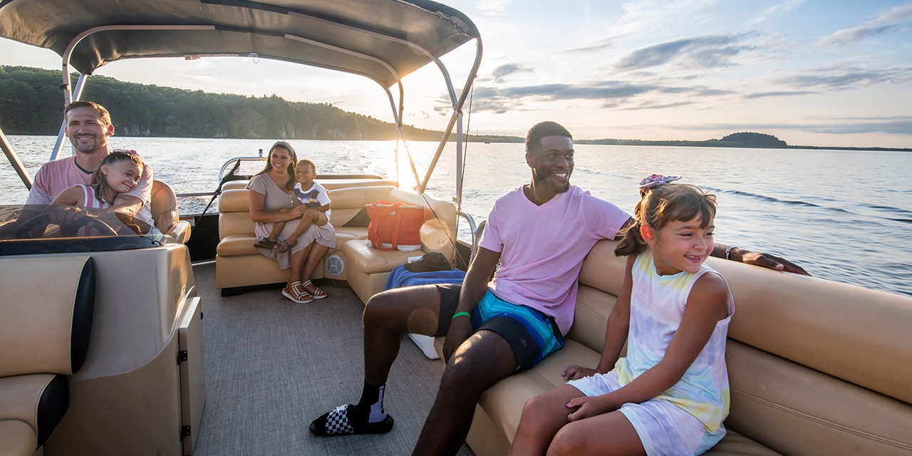 A group of people on a pontoon boat.