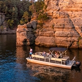 People exploring Wisconsin Dells on a pontoon boat.