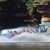A jet boat zips past the unique rock formations in Wisconsin Dells.