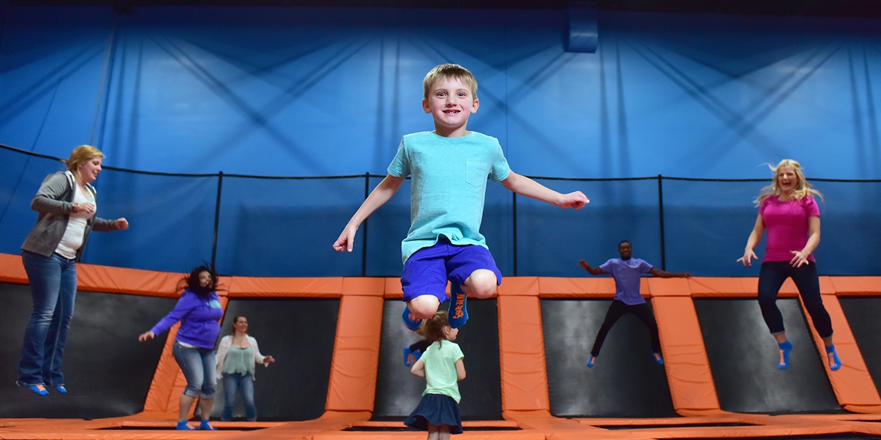 People jumping in the trampoline park.