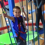 A boy on the indoor ropes course.