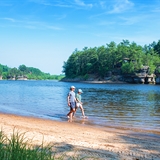 People walking on a beach on Wisconsin River.