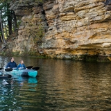 A family kayaks on Mirror Lake.