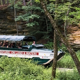 A duck boat goes past the Wisconsin Dells scenery.