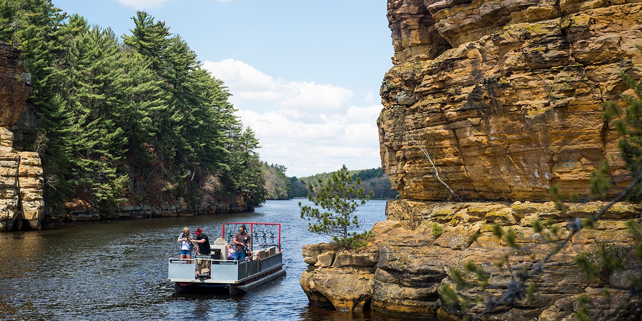 People fish from a boat in Wisconsin Dells.