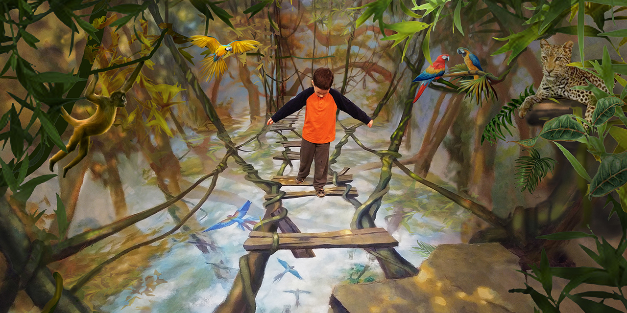 A boy playing in a rainforest room.