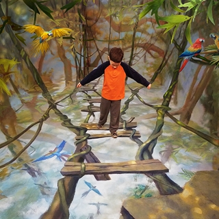 A boy playing in a rainforest room.