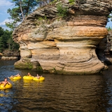 People tube on the water near major rock formations in Wisconsin Dells.