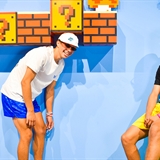 Two people pose in a Super Mario Bros. set.