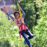A kid going across a zipline.