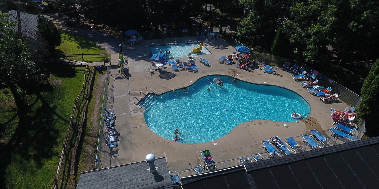 People enjoy the outdoor pool and poolside seating.
