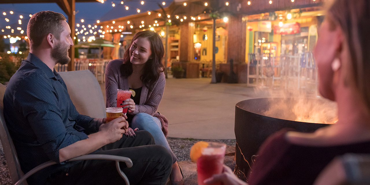 Couple sitting by fireplace.