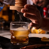 A bartender finishes making a cocktail.