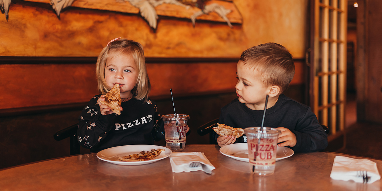 Kids eating pizza at Pizza Pub in Wisconsin Dells.