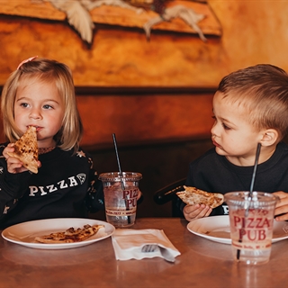 Kids eating pizza at Pizza Pub in Wisconsin Dells.