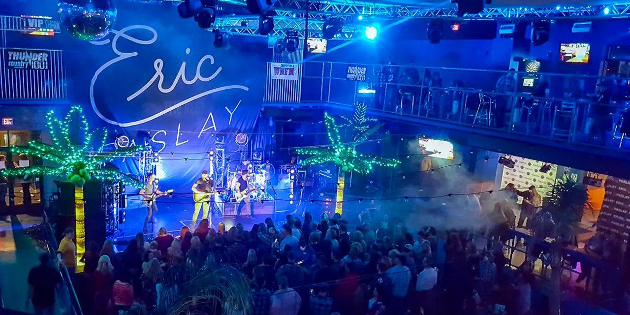 People watch live music at The Reef.