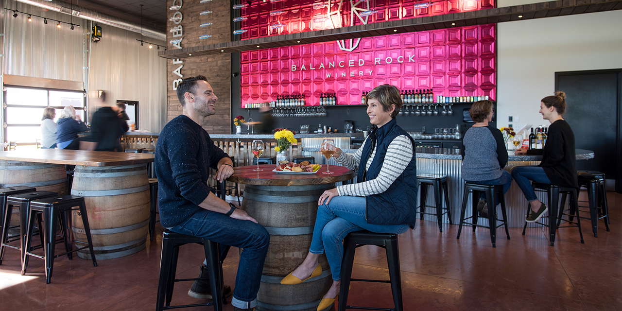 A couple having wine and a charcuterie board at Balanced Rock Winery.