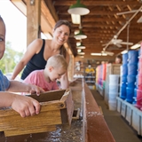 A family panning for gems at Dells Mining Co. - Lake Delton.