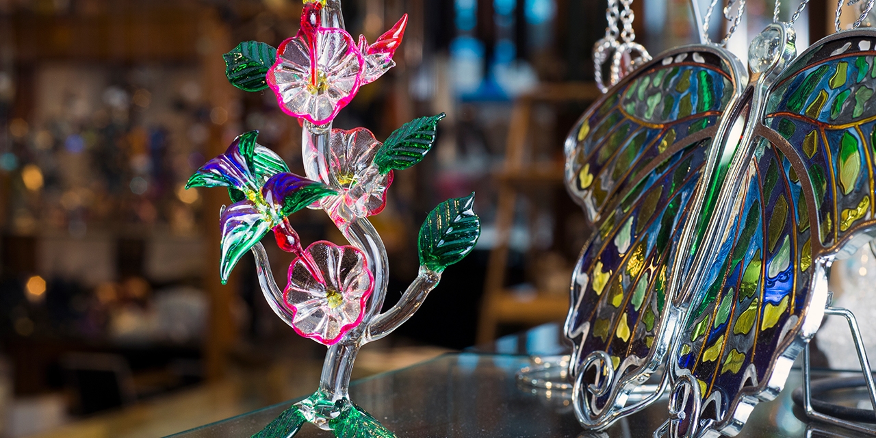 Glass flowers and leaves and a glass butterfly.