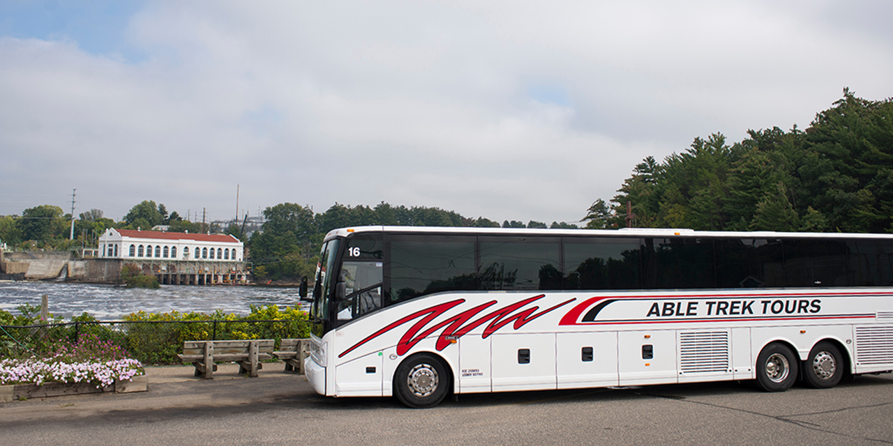 Able Trek Tours bus near the Wisconsin River.